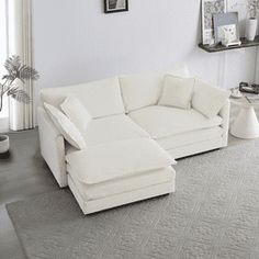 a living room with a large white sectional couch