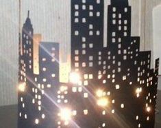 the new york skyline is made out of paper and has lights on top of it