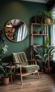 a living room with green walls and potted plants in the corner, along with a round mirror