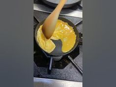 a frying pan filled with yellow liquid on top of a stove next to an oven