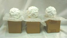 three brown boxes with white frosting on them