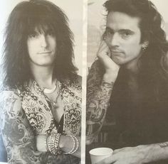 two men with long hair and tattoos on their arms, one holding a coffee cup