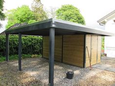 a large wooden shed sitting in the middle of a yard