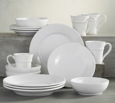 white dishes are stacked on top of each other