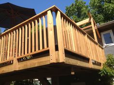 a wooden deck with an umbrella over it