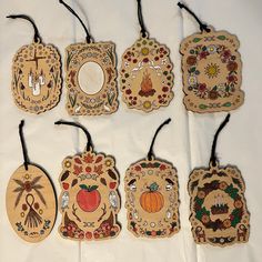 six handmade wooden tags with designs on them