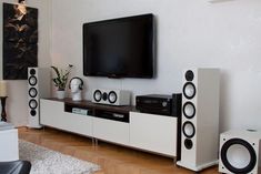 an entertainment center with speakers and a flat screen tv