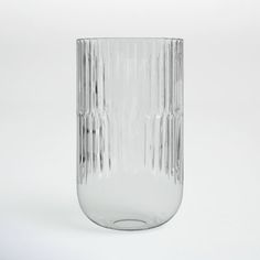 a clear glass vase sitting on top of a white table