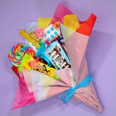 a colorful paper bag filled with candy and candies