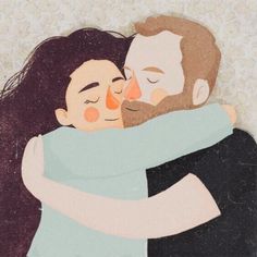 two people hugging each other with their eyes closed