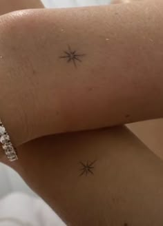 a woman's arm with two small stars on the left side of her arm