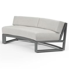 an outdoor sectional sofa is shown in grey and white fabric, as well as the back end