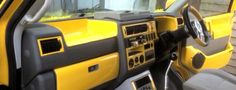 the interior of a yellow and black truck