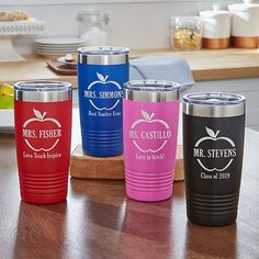 four personalized stainless steel tumblers on a kitchen counter