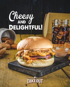 a cheeseburger on a cutting board with tater tots in the background