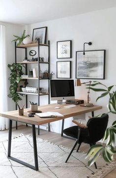 a home office with two computer desks and plants