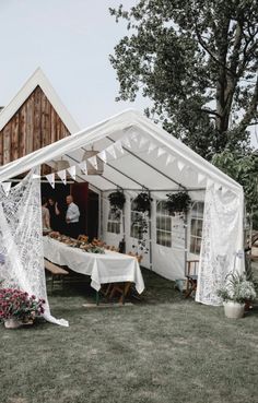 a white tent set up with tables and chairs