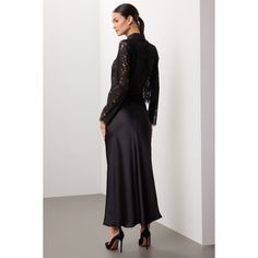 Black lace (55% Nylon, 45% Cotton). Top. Long sleeves. Collar. Front button closure. 22" from shoulder to hemline. Imported. Elegant Lace Patchwork Top For Fall, Elegant Fall Lace Patchwork Top, Elegant Delicate Lace Top For Fall, Lace Collar Top For Daywear In Fall, Formal Fall Lace Top With Lace Trim, Evening Long Sleeve Lace Top With Lace Trim, Fall Lace Top For Workwear With Lace Trim, Formal Lace Top With Lace Trim For Fall, Fall Lace Top With Lace Collar For Daywear