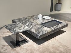 a marble coffee table with two trays on it