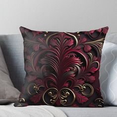 a red and gold pillow sitting on top of a couch