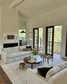 a living room filled with furniture and a fire place in the middle of a room