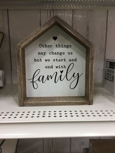 a sign that says, other things may change us but we start and end with family