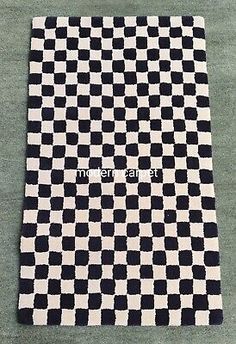 a black and white checkered area rug with the word's in cursive writing