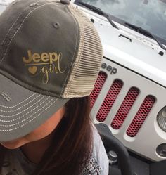 a woman wearing a jeep hat with the word jeep girl on it