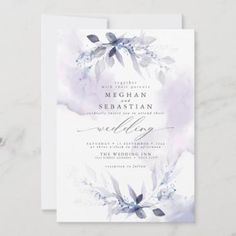 a wedding card with watercolor flowers and leaves on the front, in blue tones