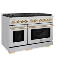 a white and gold stove with two ovens on it's sides, both side by side