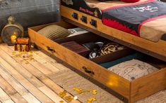 a bed with two drawers on the bottom and one drawer open to show items inside