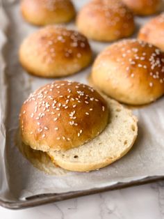 sesame seed bagels on a baking sheet