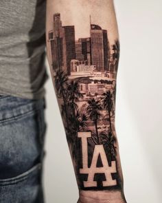 a man with a tattoo on his arm that has the word los angeles in it