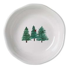 a white plate with trees painted on it