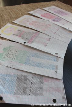 several pieces of paper are laid out on top of a piece of cardboard with crayons