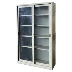 an empty metal cabinet with glass doors on the front and bottom, against a white background