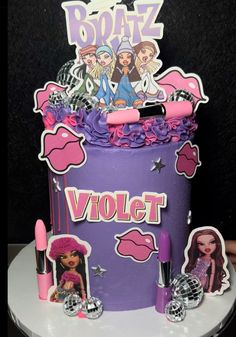 a birthday cake made to look like a purple bag with barbie dolls on the top