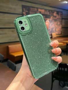 a person holding an iphone case in their hand with glitter on the back and sides