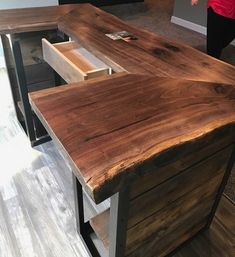 an office desk made out of wooden planks and metal legs with drawers on each side