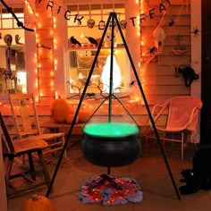 halloween decorations in front of a house with lights and pumpkins on the windowsill