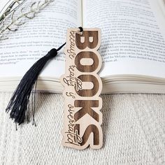 a bookmark with the word books on it and a tassel hanging from it