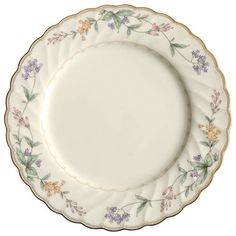 a white plate with flowers on it and gold trimming around the edge, against a white background