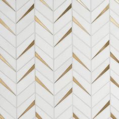 a white and gold herringbone tile wallpaper with metallic lines on the bottom half