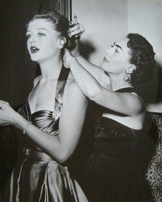 an old photo of two women brushing each other's hair