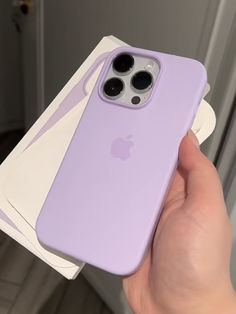 a person holding an iphone 11 in front of the camera with its case open and two stickers attached to it