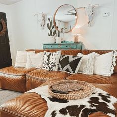 a living room filled with lots of brown furniture