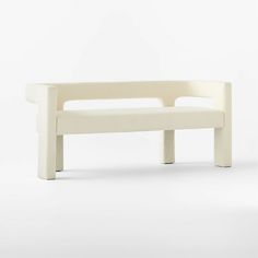 a white bench sitting on top of a white floor