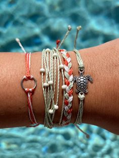 Bring the good luck with you in our Turtle Bracelet Stack! Feautring a delicate sea turtle charm and summer colors, this set is sure to stand out!  Waxed Cord, approx 5.5" with 6" adjustable sliding knot - adjustable and waterproof! Silver circle charm Antique silver turtle charm Frosted beads Make waves in this set and showcase your love for all things beachy in this style. Put a smile on her face with this special gift. Our jewelry is handmade in the Sunshine State with local materials and shipped with an effort to use environmentally friendly packaging, making it the perfect choice for those who shop with a green mindset. Beachy Things To Buy, Boho Surfer Style, Surf Bracelets, The Island Princess, Being Aesthetic, Surfer Look, Beachy Bracelets, Surfer Jewelry, 30a Florida