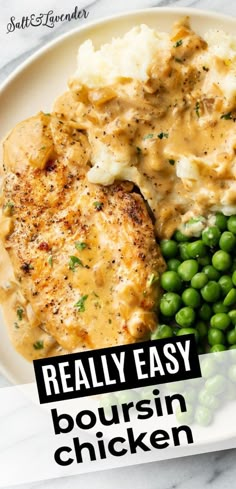 a white plate topped with chicken, mashed potatoes and peas