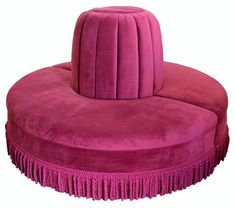 a pink round chair with fringe trim around the seat and footrests, on a white background